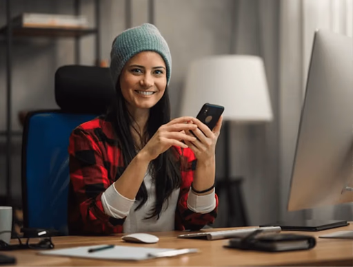 A woman sitting at desk on a phone