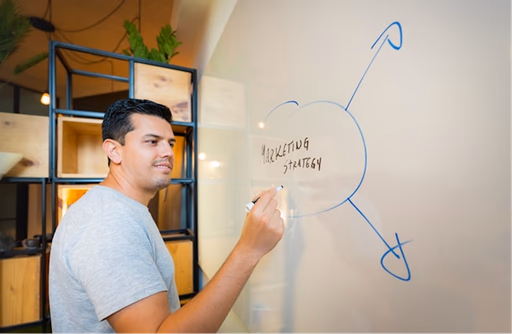 A man writing on white board